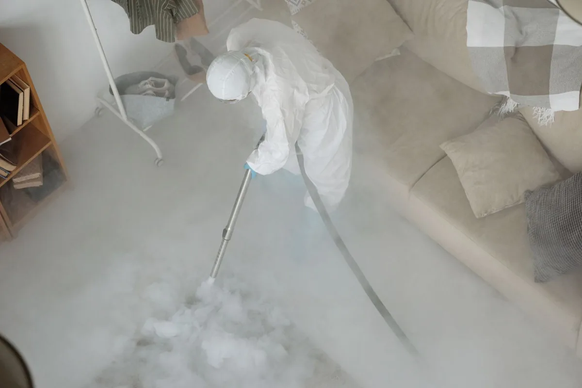 Biohazard cleanup technician in protective equipment, Veazie, ME